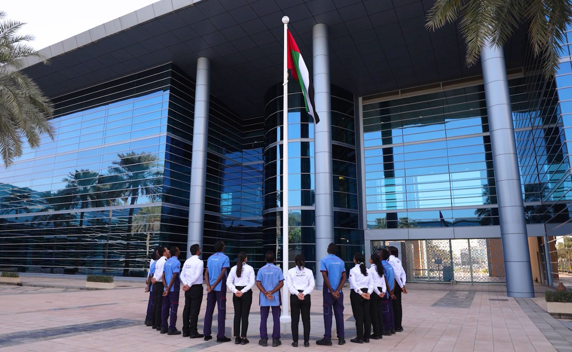 MEBS employees raising the UAE flag during National Day CSR celebration