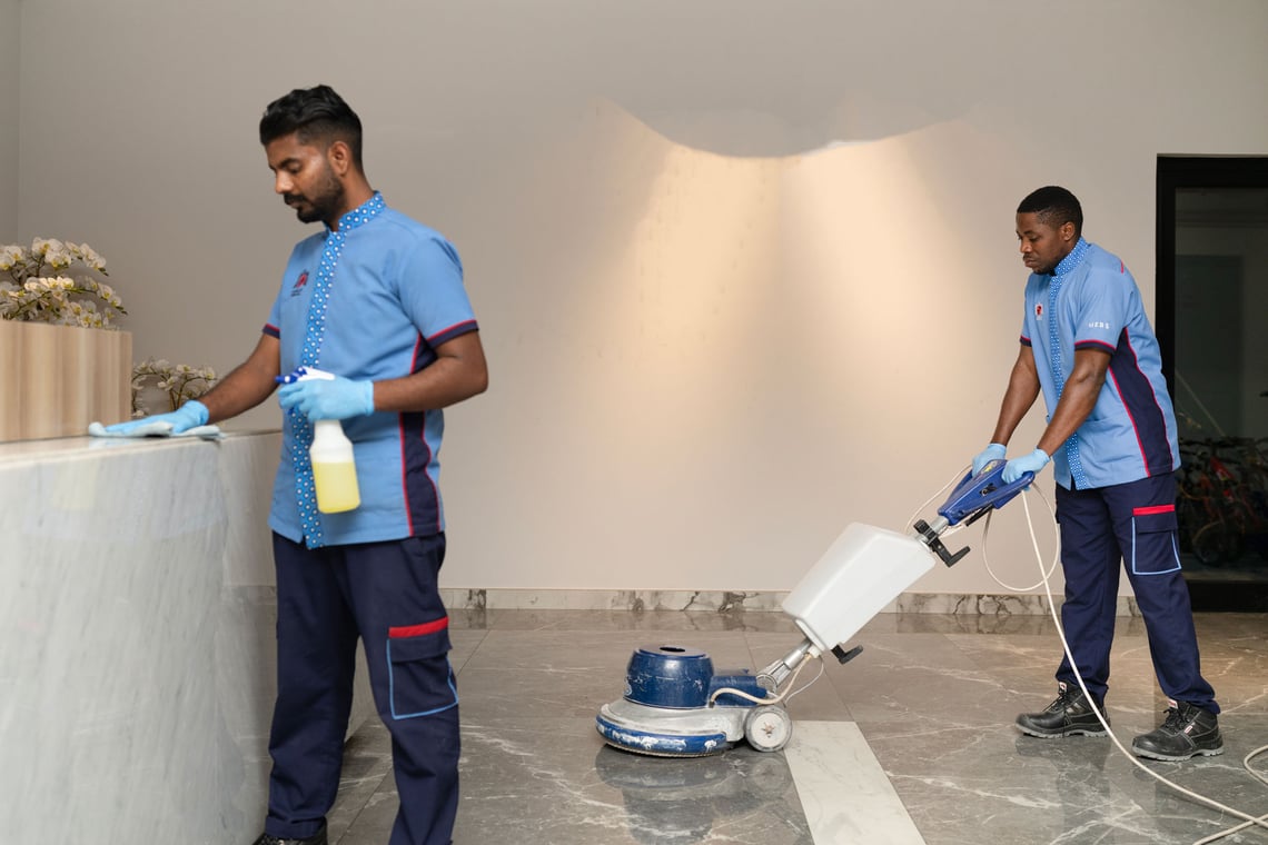 Professional cleaners addressing Dubai-specific climate challenges in a business setting