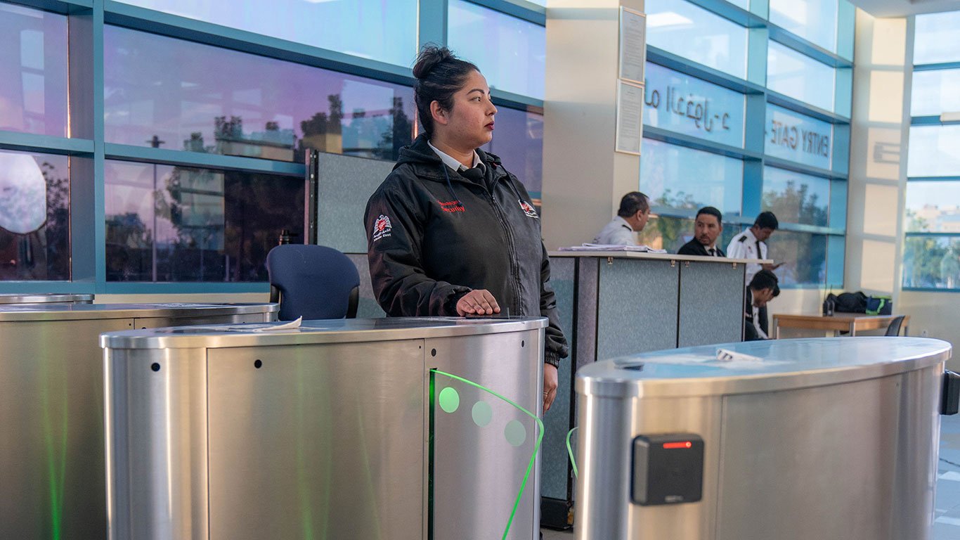 Professional security guard managing access control at a commercial building in Dubai