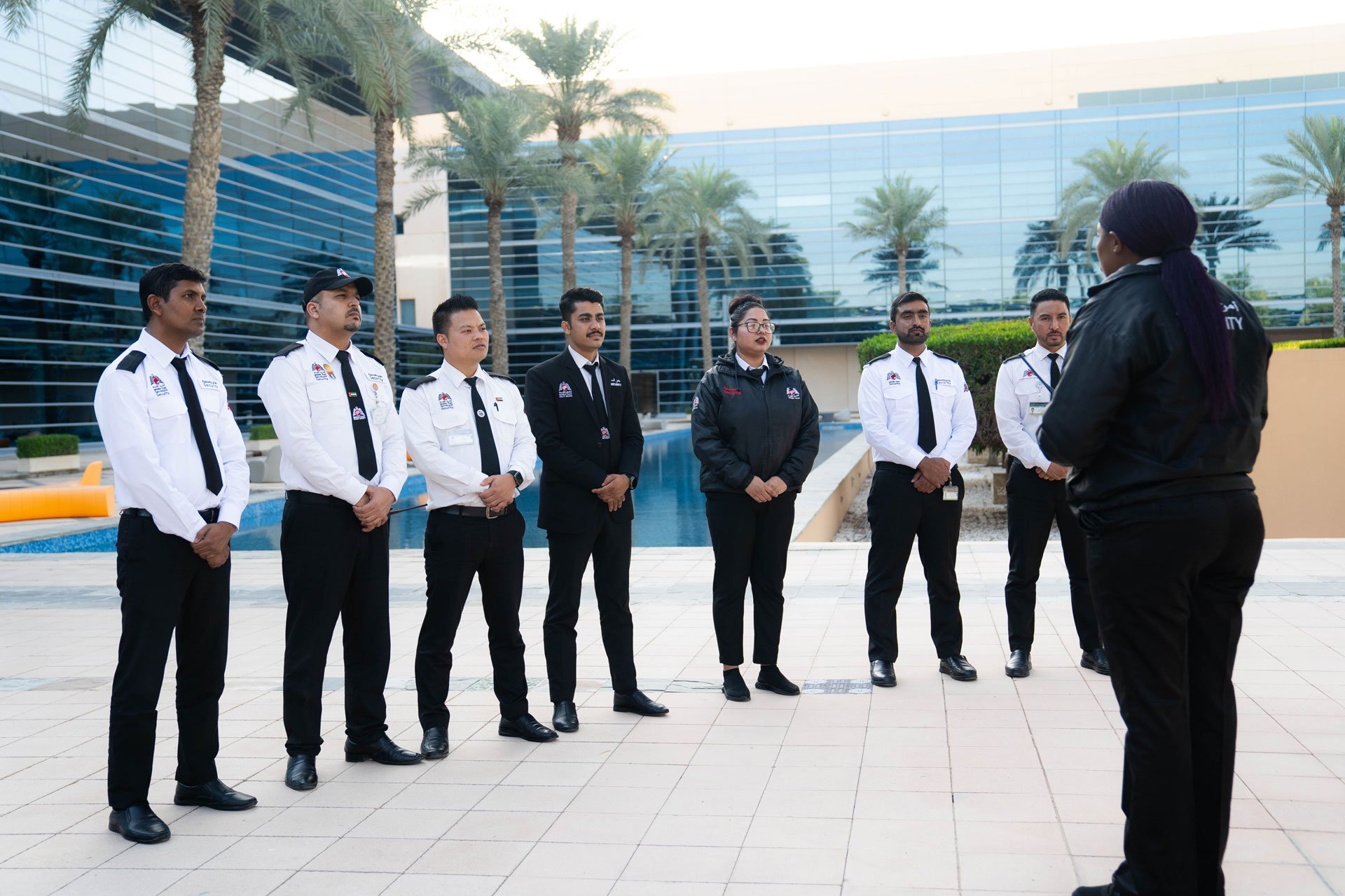 Professional security guard assisting visitors at a Dubai office building
