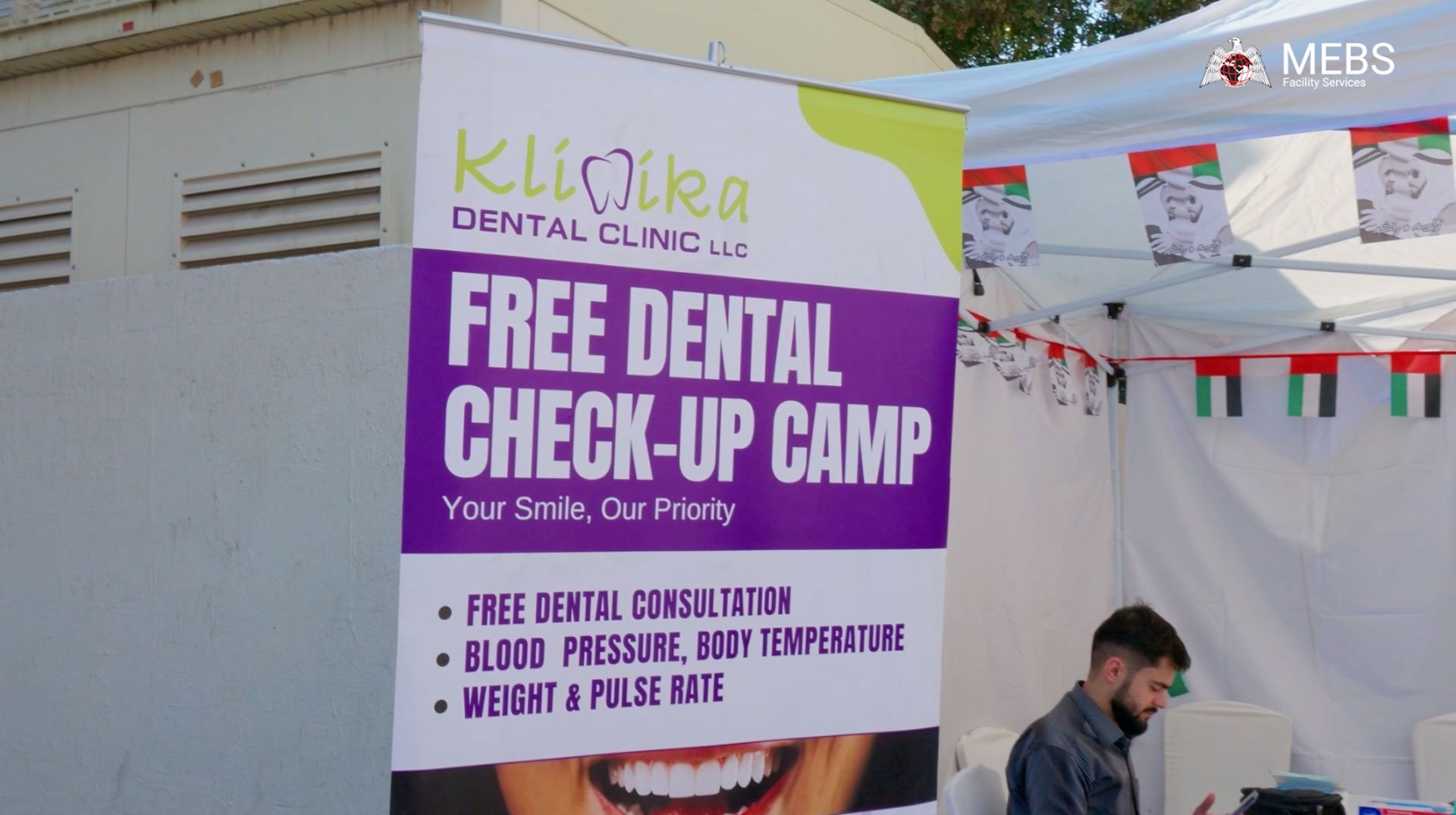 Staff receiving dental hygiene guidance at MEBS Facility Services corporate CSR health camp